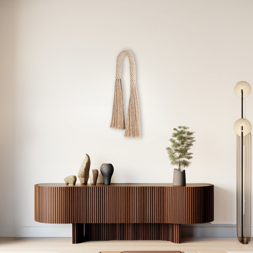 Fiber art wall hanging featuring a knotted tassel design- Aarya in a oat color,made from cotton rope showcasing intricate design and knotwork handcrafted by Yashi Designs.