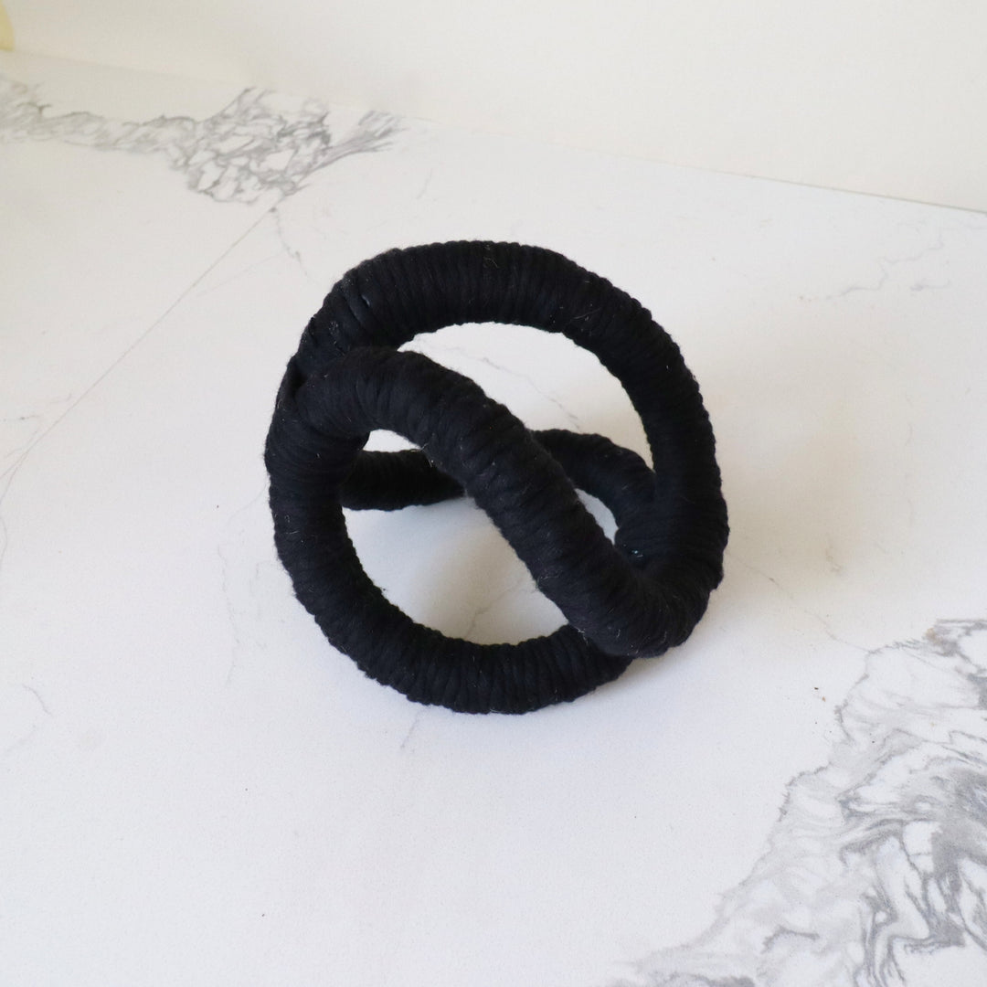 coffee table sculpture- Infinity loop Knot in black color. A bold, three-dimensional abstract rope sculpture, is handmade with one continuous piece of rope for table and shelf decor.