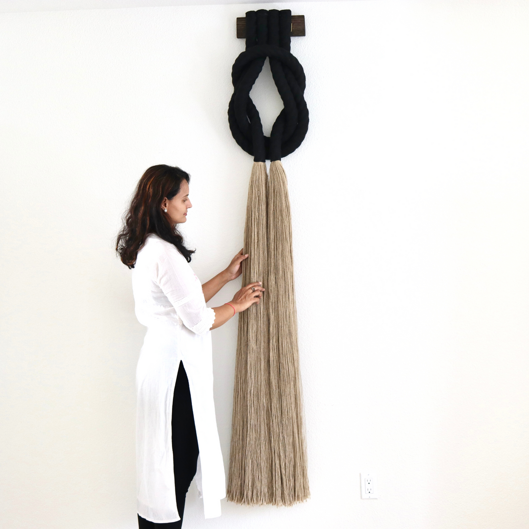 Minimalist beige rope design wall hanging with a long tassel, created by Yashi Designs as a serene addition to any space and interior