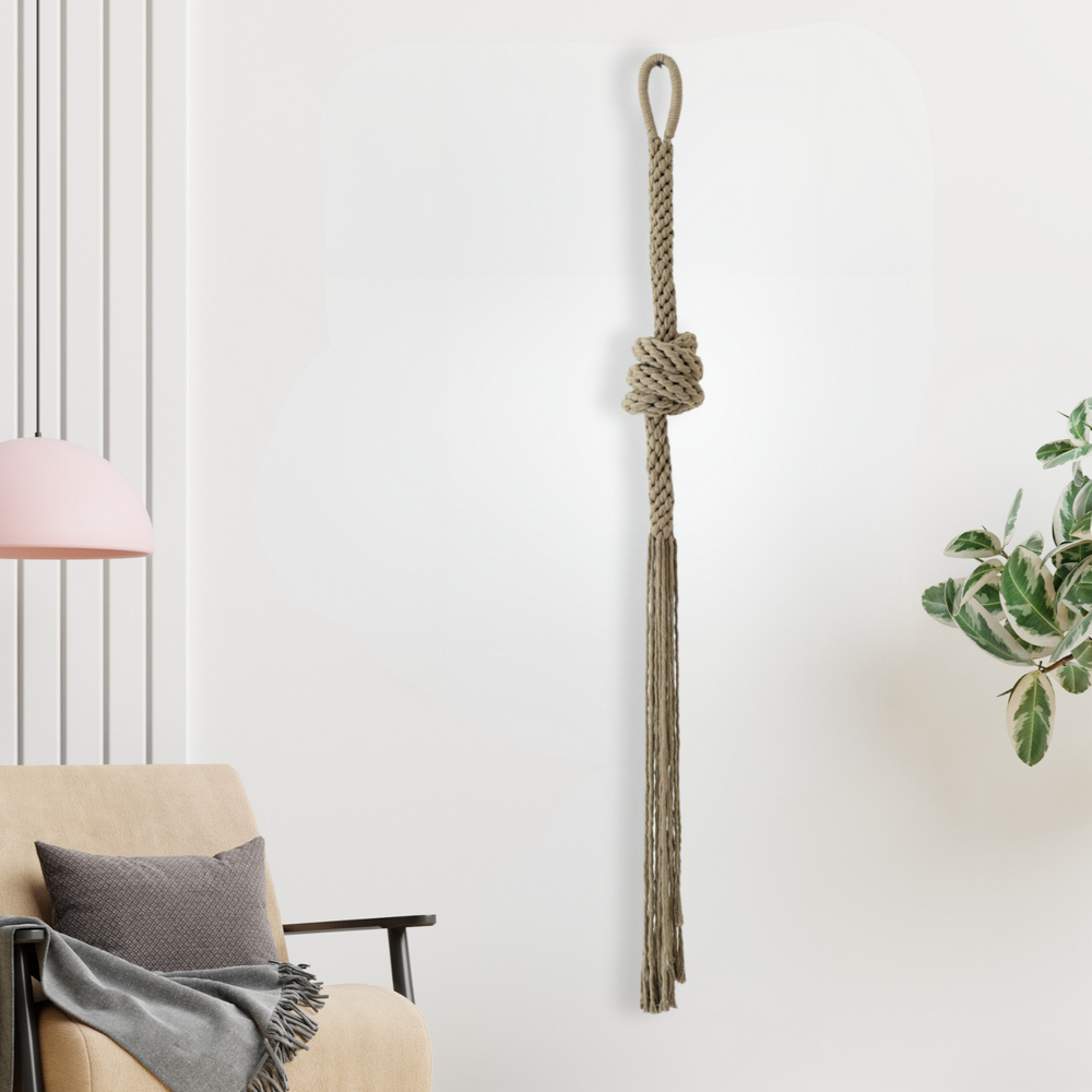 Tan hand-knotted rope sculpture with intricate details, adding artistic flair to a bright modern interior.