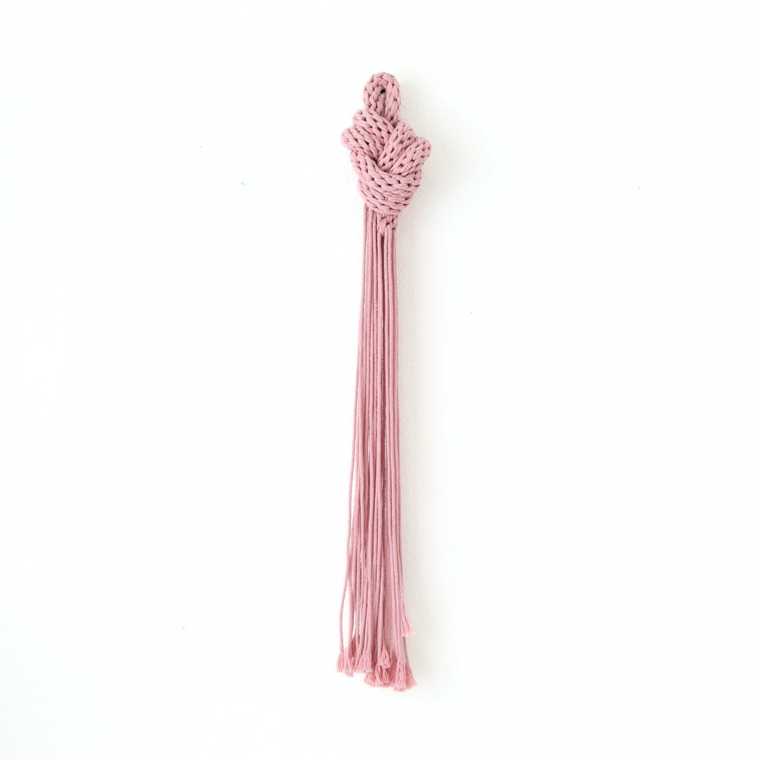 Handcrafted knotted sculpture made from natural pink cotton rope, showcasing intricate knotwork and modern design.