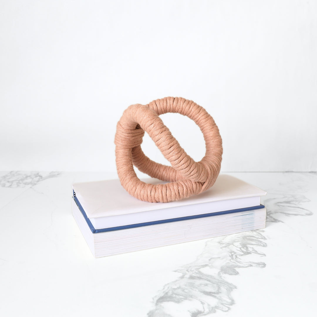 Handmade knotted rope sculpture for table decor by Yashi Designs made from peach color organic cotton rope, showcasing intricate knotwork and modern design. Perfect for housewarming gifts and luxury home decor.