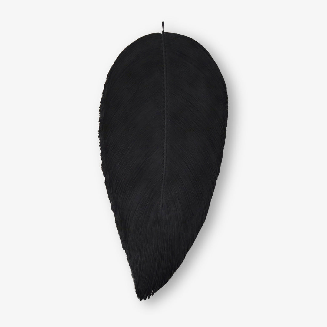 Sleek black fiber art leaf sculpture creating a bold statement piece for monochrome or minimalist decor styles in any luxury interior.