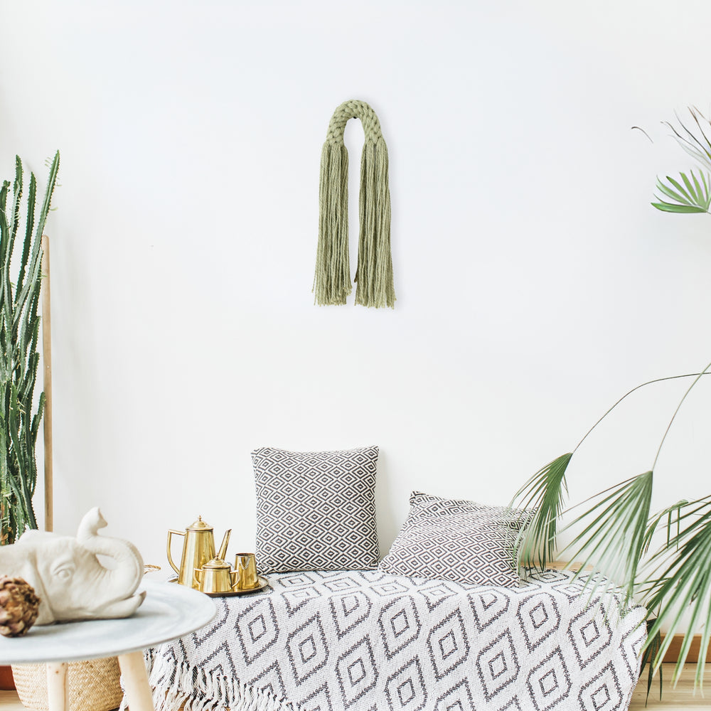 Small hemp tassel in sage green, a handcrafted Natural Dimensional Wall Art by Yashi Designs, minimalistic and modern wall hanging.