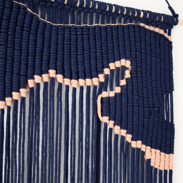 Navy blue macrame wall hanging with an unique design of artwork, creating a stunning visual contrast and contemporary elegance in any wall decor and luxury interior    