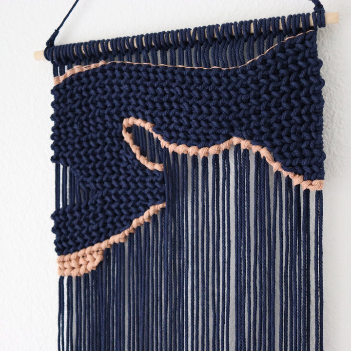 Navy blue macrame wall hanging with an unique design of artwork, creating a stunning visual contrast and contemporary elegance in any wall decor and luxury interior. 