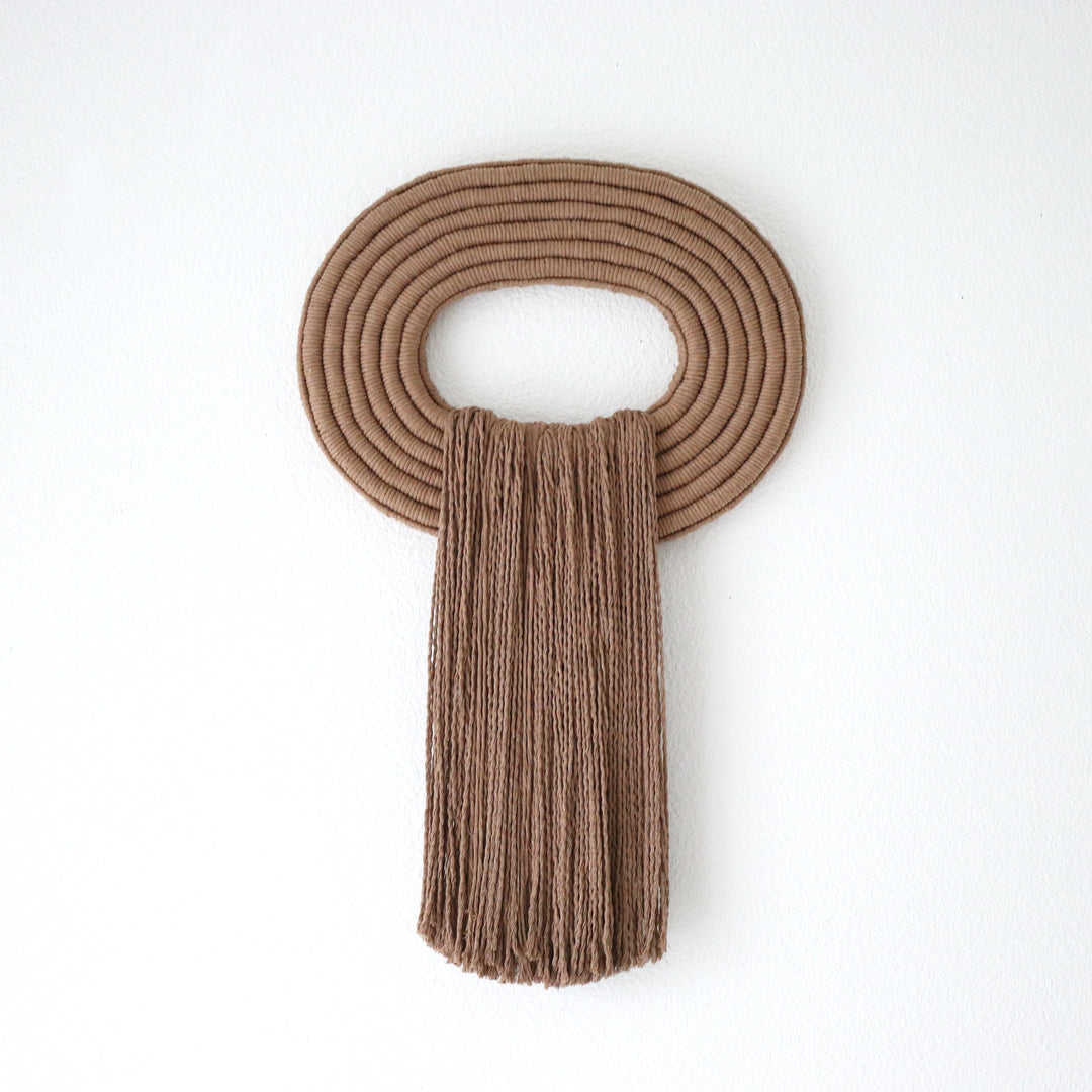 Elegant wall hanging tassel with a attractive brown circular accent for a modern decorative touch with Contemporary Wall hangings