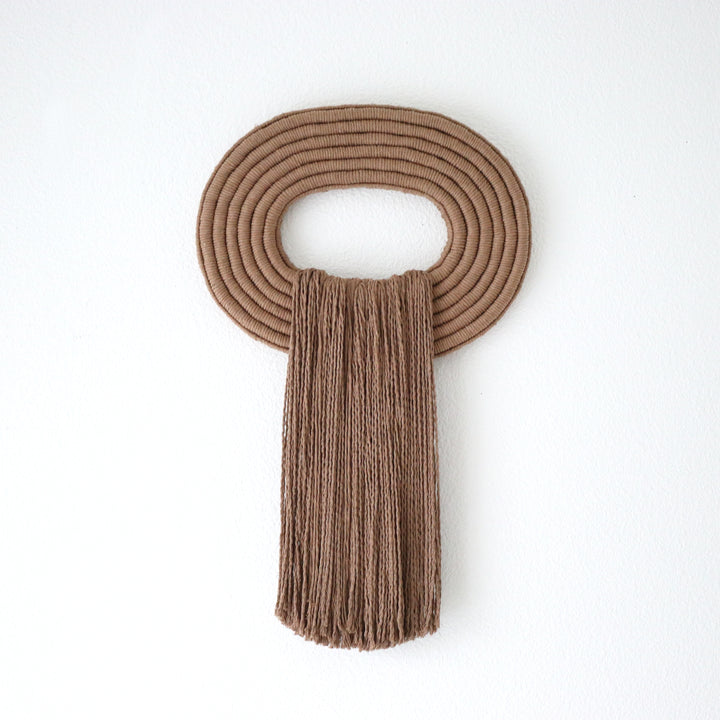 Elegant wall hanging tassel with a attractive brown circular accent for a modern decorative touch with Contemporary Wall hangings