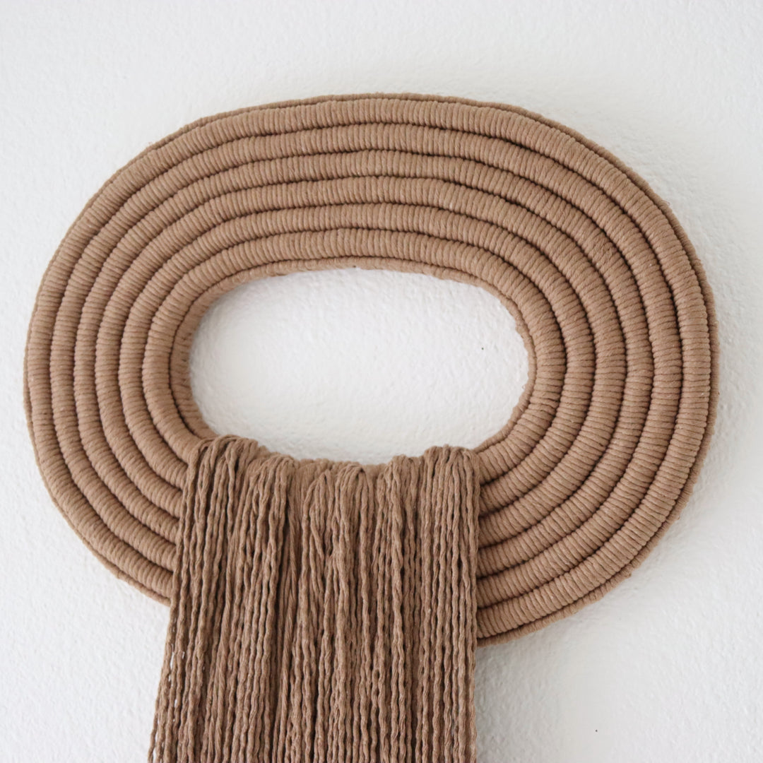 Elegant wall hanging tassel with a attractive brown circular accent for a modern decorative touch with Contemporary Wall hangings