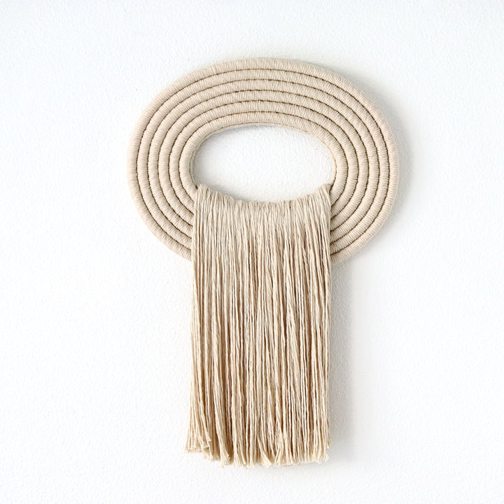 Elegant beige wall hanging tassel with a distinctive beige circular accent for a modern decorative touch with Contemporary Wall hangings