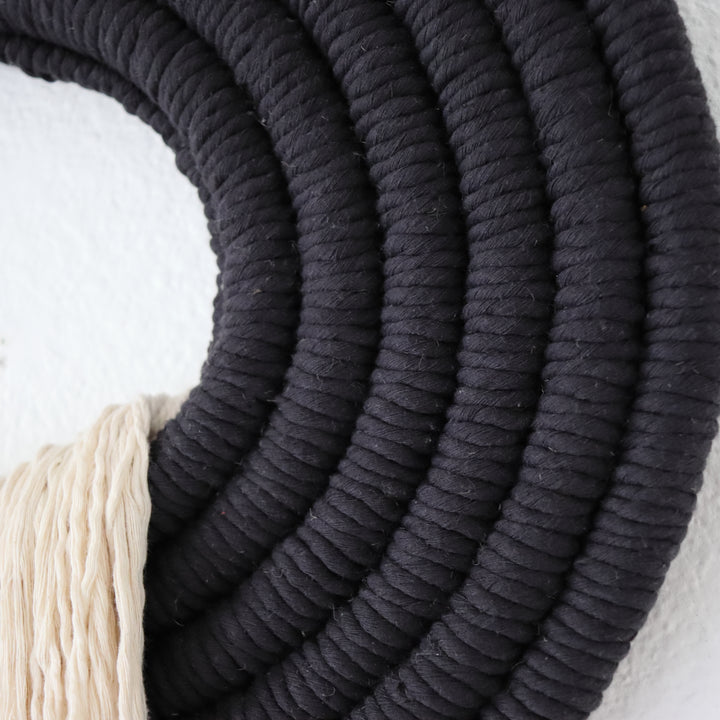 Elegant beige wall hanging tassel with a distinctive black circular accent for a modern decorative touch with Contemporary Wall hangings