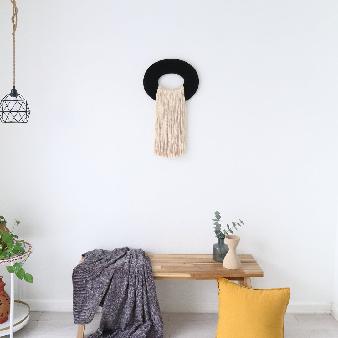 Elegant beige wall hanging tassel with a distinctive black circular accent for a modern decorative touch with Contemporary Wall hangings