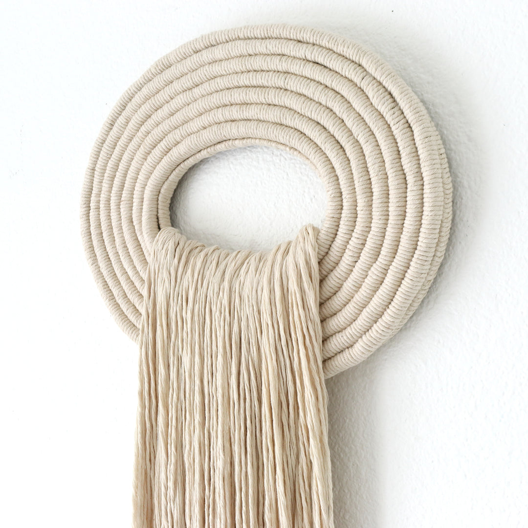 Elegant beige wall hanging tassel with a distinctive white circular accent for a modern decorative touch with Contemporary Wall hangings