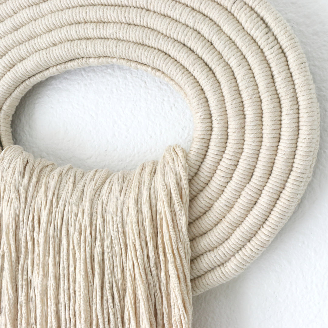 Elegant beige wall hanging tassel with a distinctive white circular accent for a modern decorative touch with Contemporary Wall hangings
