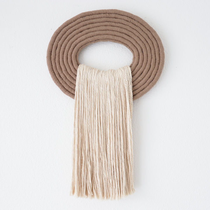 Elegant white wall hanging tassel with a distinctive beige circular accent for a modern decorative touch with Contemporary Wall hangings