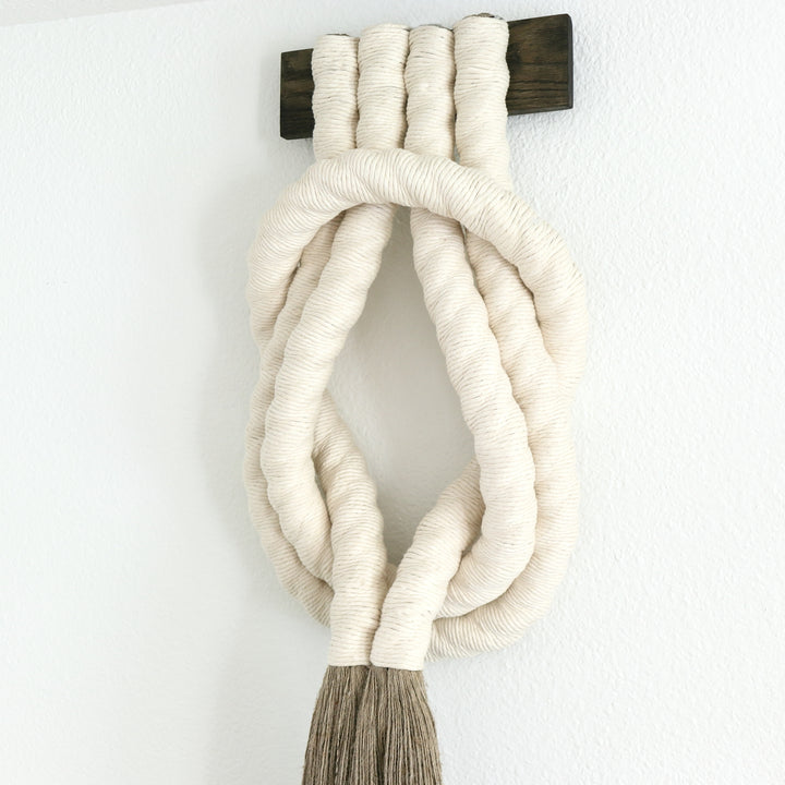 Minimalist beige rope design wall hanging with a long tassel, created by Yashi Designs as a serene addition to any space and interior, Customized Art Installations, Sustainable Fiber Art