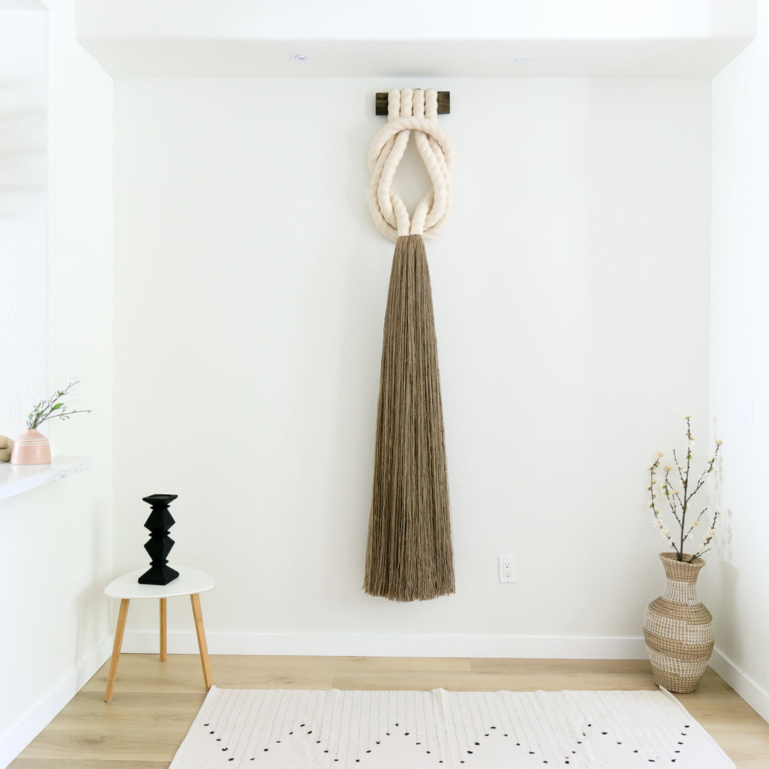 Minimalist beige rope design wall hanging with a long tassel, created by Yashi Designs as a serene addition to any space and interior, Customized Art Installations, Sustainable Fiber Art