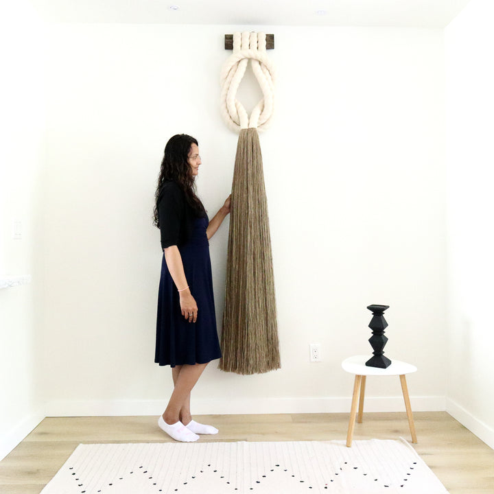 Minimalist beige rope design wall hanging with a long tassel, created by Yashi Designs as a serene addition to any space and interior, Customized Art Installations, Sustainable Fiber Art