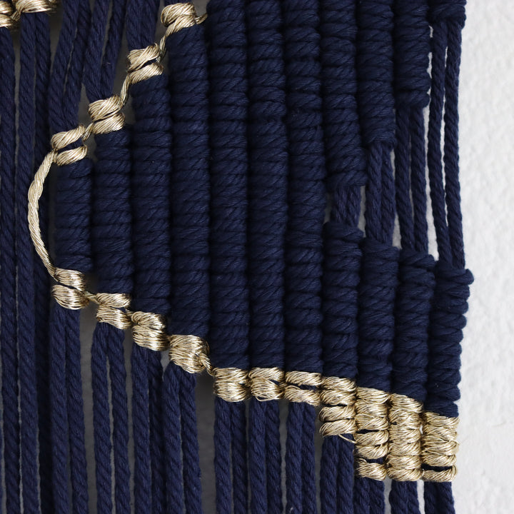 Contemporary navy blue macrame wall hanging with unique and modern beige design, creating a modern and artistic statement in any space or interior