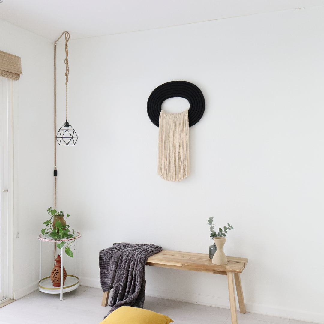 Elegant beige wall hanging tassel with a distinctive black circular accent for a modern decorative touch with Contemporary Wall hangings