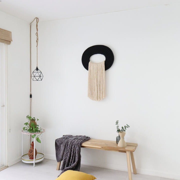 Elegant beige wall hanging tassel with a distinctive black circular accent for a modern decorative touch with Contemporary Wall hangings