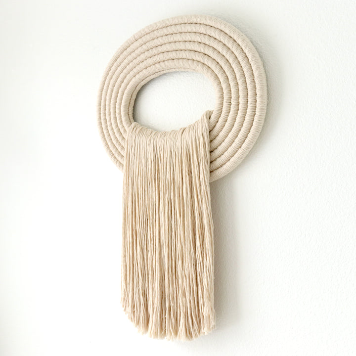 Elegant beige wall hanging tassel with a distinctive beige circular accent for a modern decorative touch with Contemporary Wall hangings