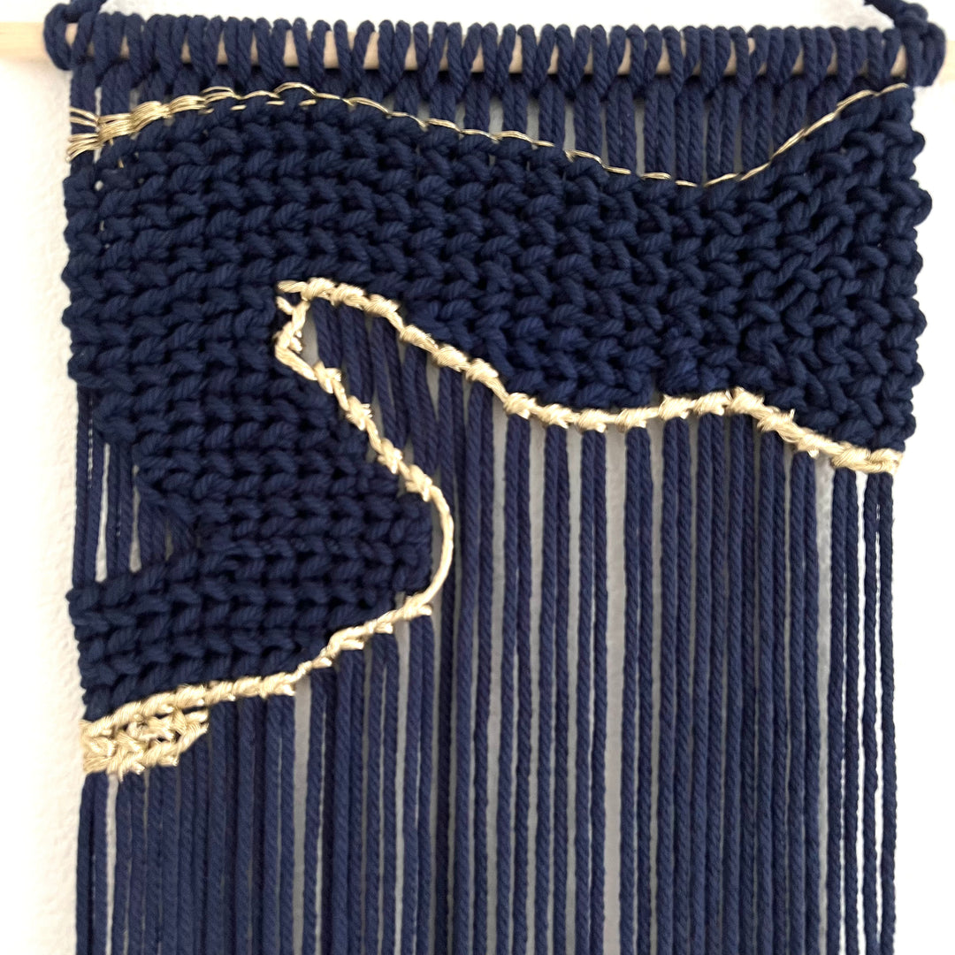 Contemporary navy blue macrame wall hanging with unique and modern beige design, creating a modern and artistic statement in any space or interior