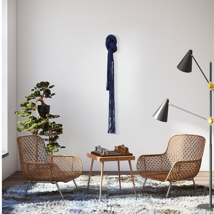 In situ display of blue knotted fiber art, showcased in the conversational space adding artistic charm to it.