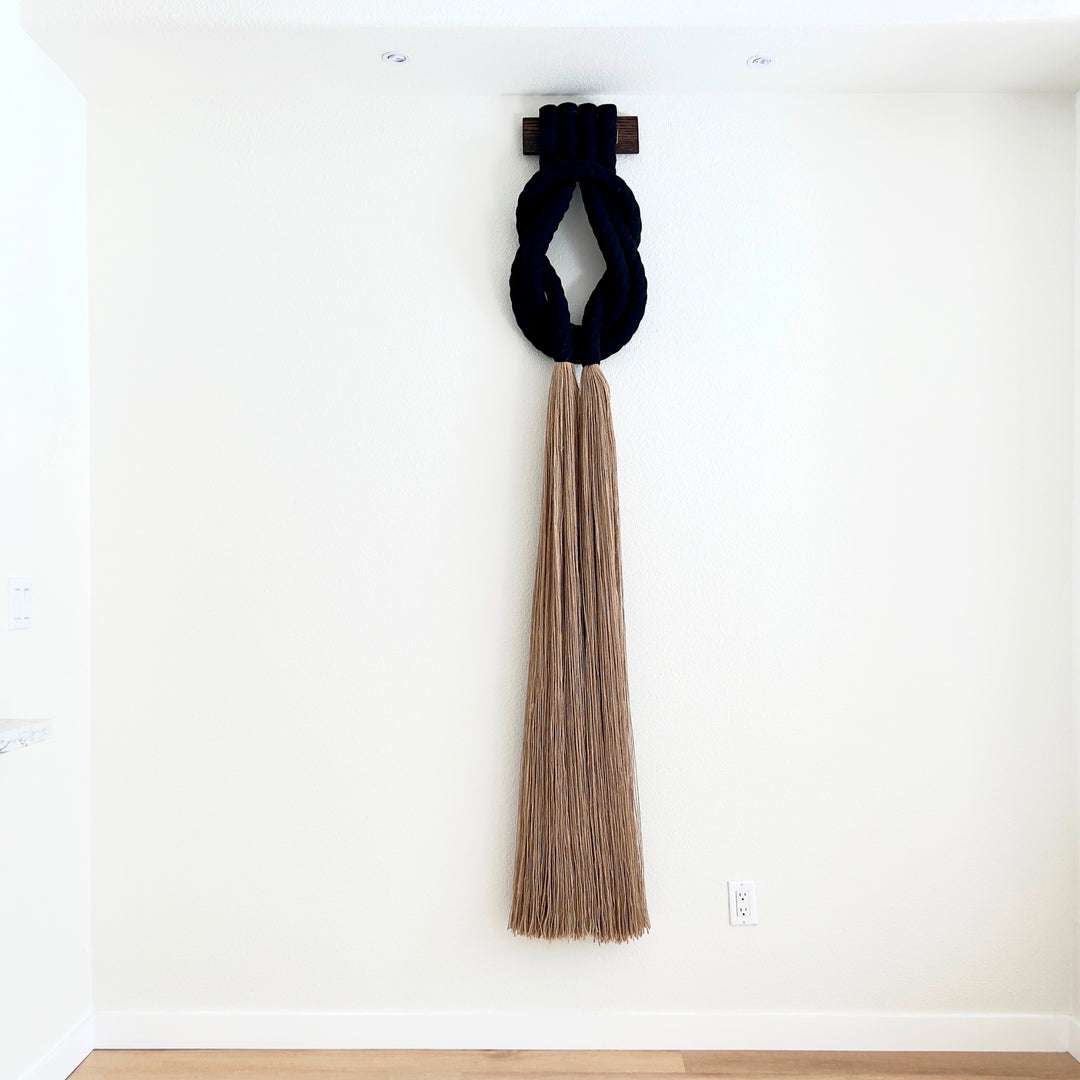 Tall Jute Rope sculpture - Forever Love Knot , Minimalist beige rope design wall hanging with a long tassel, created by Yashi Designs as a serene addition to any space and interior 