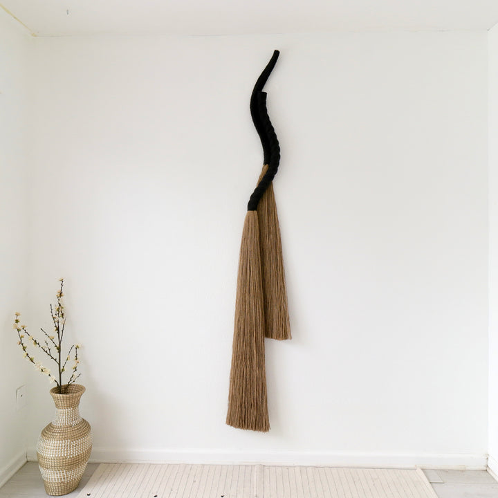 Tall knotted rope sculpture by Yashi Designs made from natural jute &  cotton, showcasing  modern sculpture that evoke emotion and connection.
