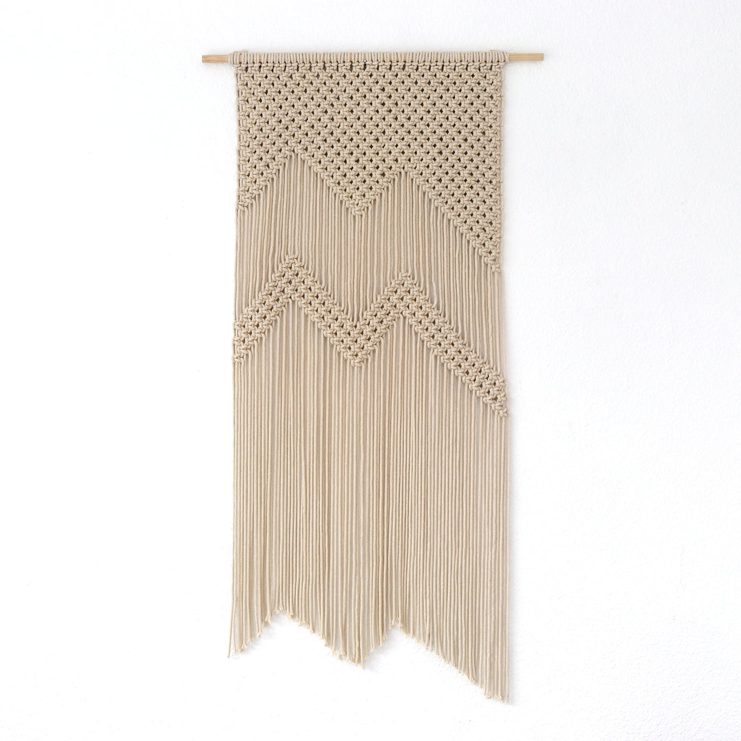 Geometric mountain-inspired macrame wall hanging in neutral tones