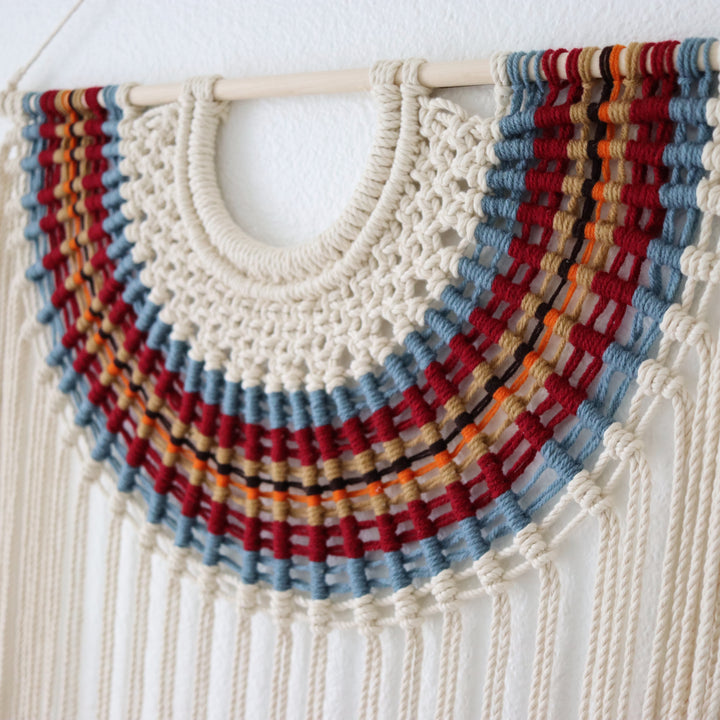 Colorful macrame wall hanging fiber art in modern interior décor