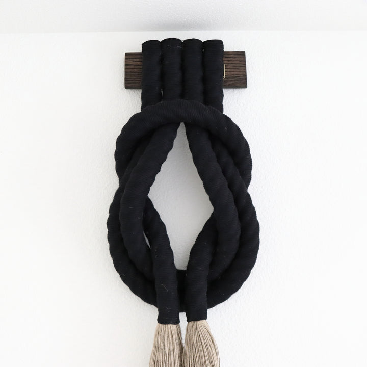 Minimalist beige rope design wall hanging with a long tassel, created by Yashi Designs as a serene addition to any space and interior 