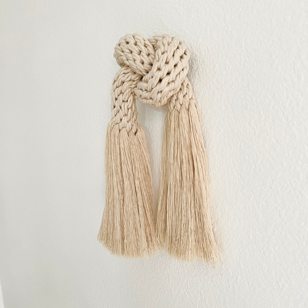 detail of Minimalist fiber art featuring a classic knot design.