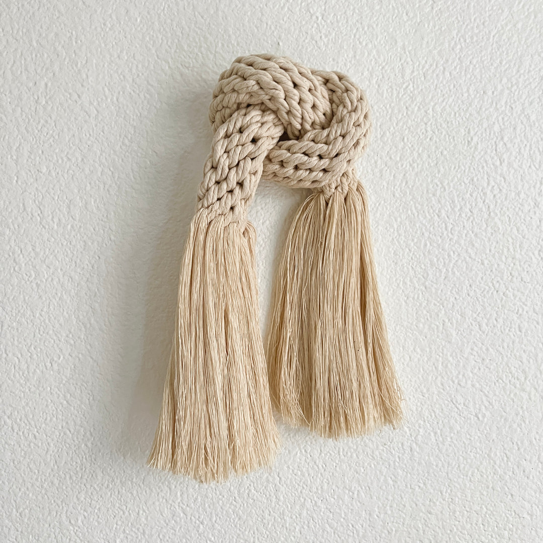 Hand-knotted cotton rope wall sculpture with flowing fringe