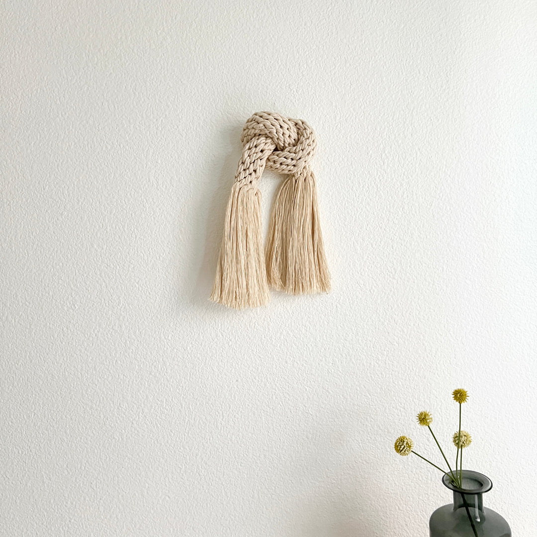 Neutral-toned knotted rope sculpture for modern interiors.