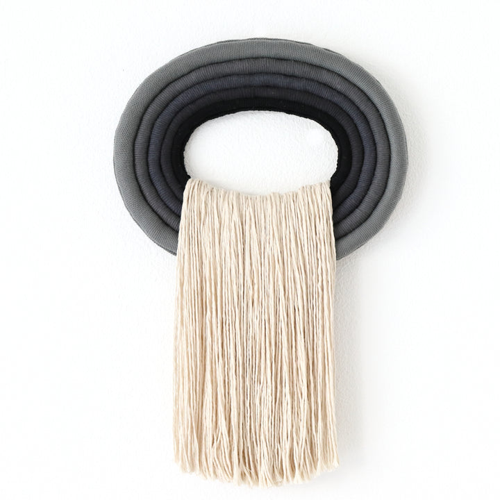Elegant grey & black wall hanging tassel with a distinctive black circular accent for a modern decorative touch with Contemporary Wall hangings