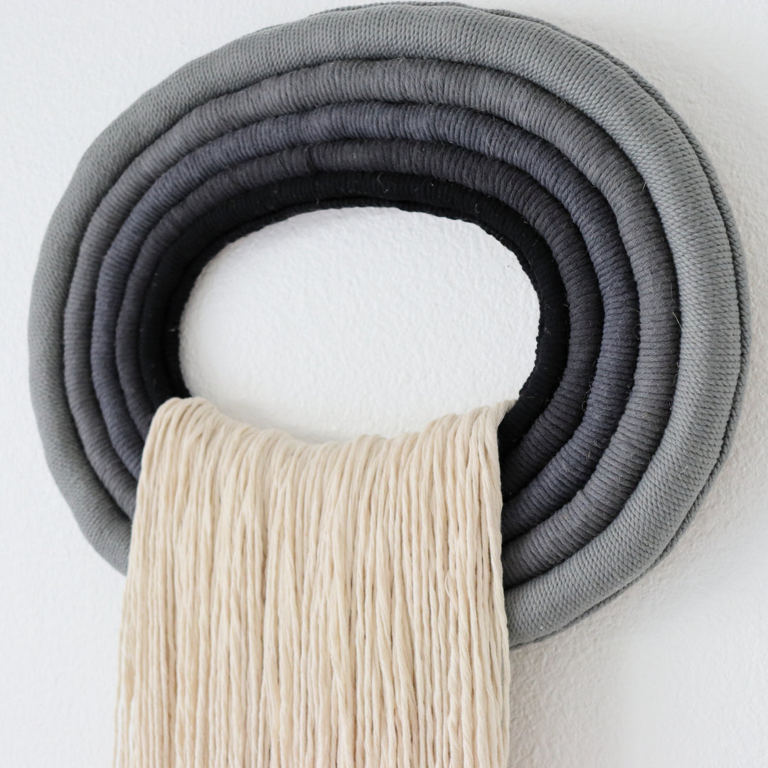 Elegant white wall hanging tassel with a distinctive grey & black circular accent for a modern decorative touch with Contemporary Wall hangings