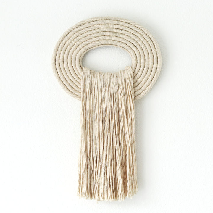 Elegant beige wall hanging tassel with a distinctive white circular accent for a modern decorative touch with Contemporary Wall hangings