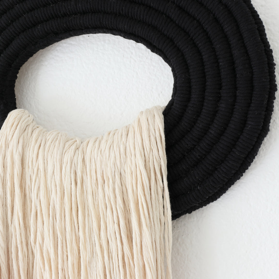 Elegant beige wall hanging tassel with a distinctive black circular accent for a modern decorative touch with Contemporary Wall hangings