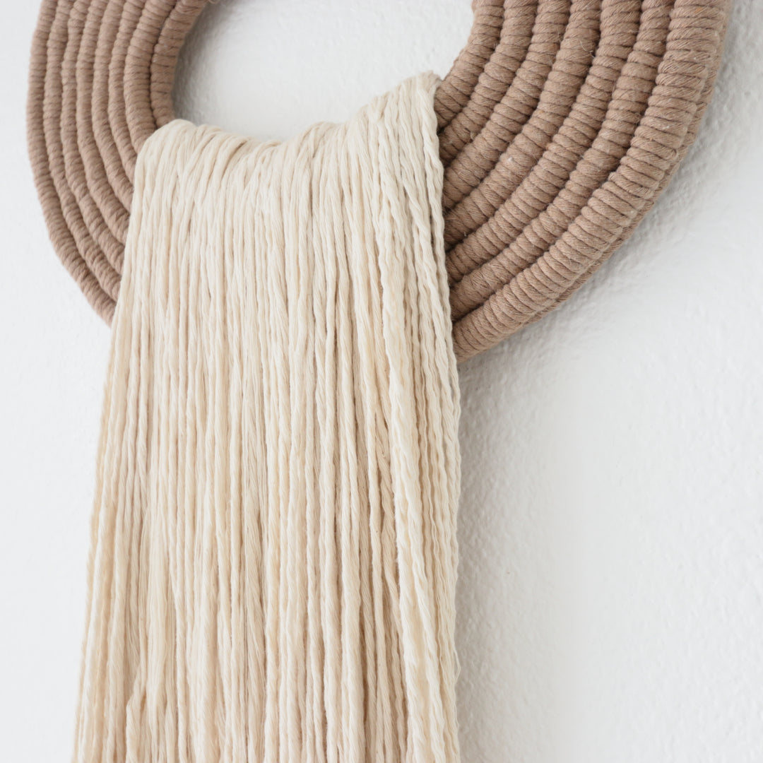 Elegant white wall hanging tassel with a distinctive beige circular accent for a modern decorative touch with Contemporary Wall hangings