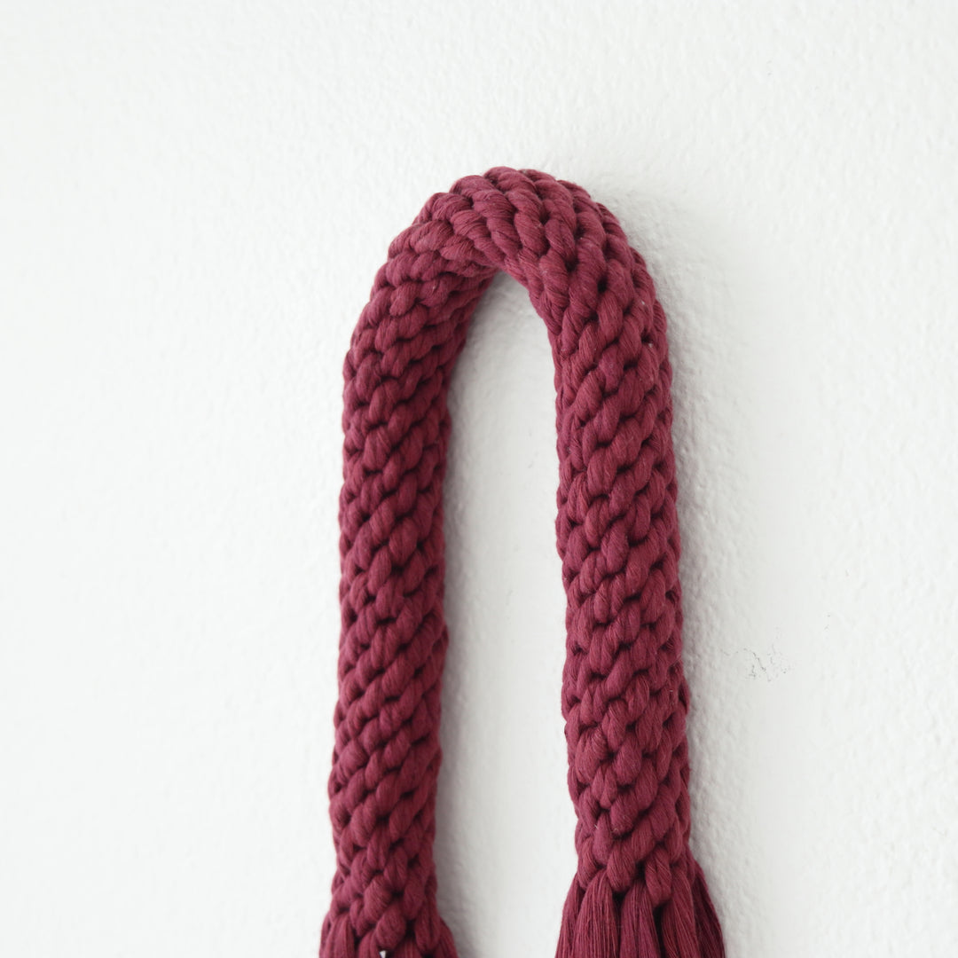 Rich wine-colored fiber art wall hanging, presenting a contemporary knotted aesthetic - Yashi Designs