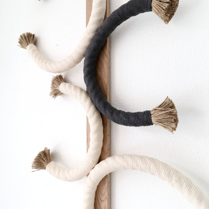 Artistic rope sculpture featuring interlaced circles with contrasting tassel accents, mounted on wood for a minimalist aesthetic, Unique Fiber Art, Earthy Tones, Jute Artworks - Coastal Farm House, Cottage Style, Eco-friendly living, Neutral Decor