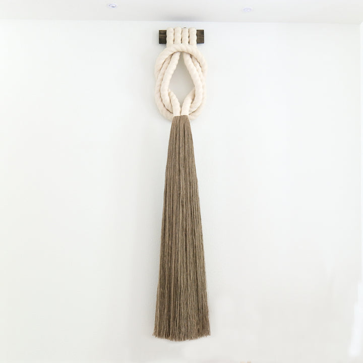 Minimalist beige rope design wall hanging with a long tassel, created by Yashi Designs as a serene addition to any space and interior, Customized Art Installations, Sustainable Fiber Art