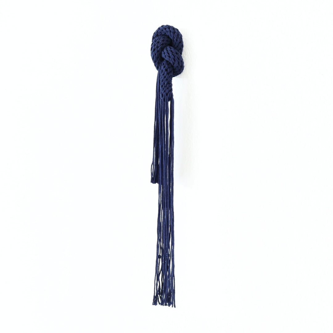 Navy blue knotted fiber art sculpture,  crafted from cotton rope with intricate design, perfect for gifting and home decor.