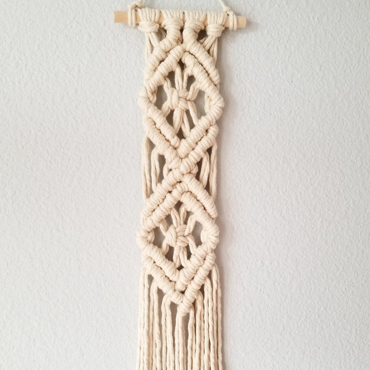 Close up on Diamond Tassel Tassel Wall Hanging-Diamond Tassel Intricate macrame wall hanging with unique pattern, handcrafted to add a rustic art touch to any decor 